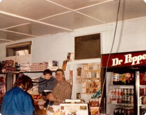 Dick Winking in 1984 holding Ricky Schmidt (Dicks grandson).  Terri Schmidt with back to camera.