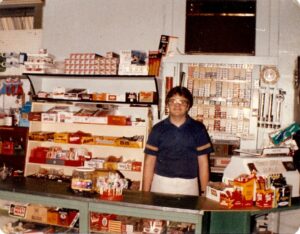 Frank Winking behind the counter at Winkings Market. Age about 17.