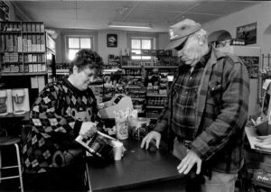 June Winking serving coffee to customer Al Siebers - picture from Quincy Herald Whig article about Winking's Market.