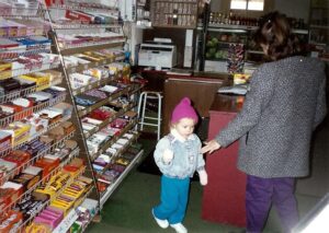 Winkings Market customer Buffy Cain (back to camera) and her niece Audriana getting candy.