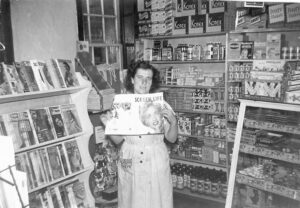 Winkings Market store magazine rack shown with customer Eileene Howe.